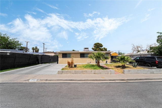 4630 Gabriel Dr, Las Vegas, NV 89121 - view of front of house featuring fence, stucco siding, and concrete driveway