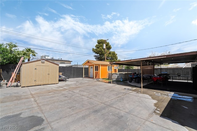 4630 Gabriel Dr, Las Vegas, NV 89121 - view of patio / terrace with a storage unit, a fenced backyard, and an outdoor structure