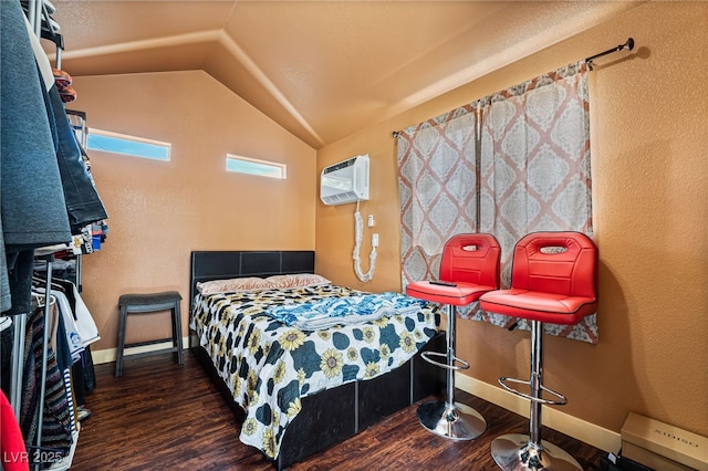 4630 Gabriel Dr, Las Vegas, NV 89121 - bedroom featuring baseboards, a wall mounted AC, wood finished floors, and lofted ceiling