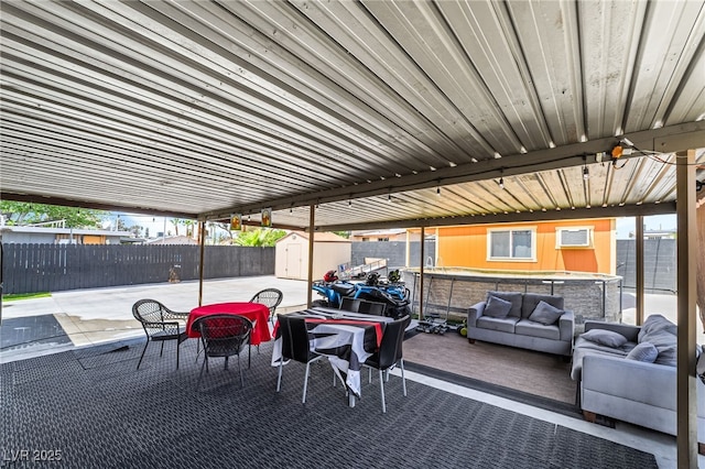4630 Gabriel Dr, Las Vegas, NV 89121 - view of patio featuring an outdoor hangout area, a shed, a hot tub, an outbuilding, and fence