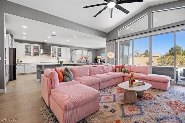 8440 Footpath St, Las Vegas, NV 89166 - living room featuring recessed lighting, a ceiling fan, light wood-style floors, and high vaulted ceiling