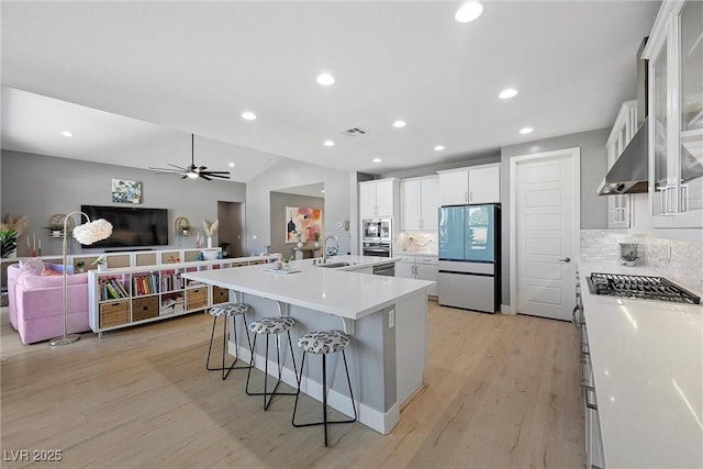 8440 Footpath St, Las Vegas, NV 89166 - kitchen featuring smart refrigerator, a sink, light wood-style floors, open floor plan, and tasteful backsplash