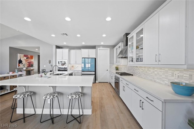 8440 Footpath St, Las Vegas, NV 89166 - kitchen featuring stainless steel appliances, a sink, a kitchen breakfast bar, white cabinetry, and recessed lighting