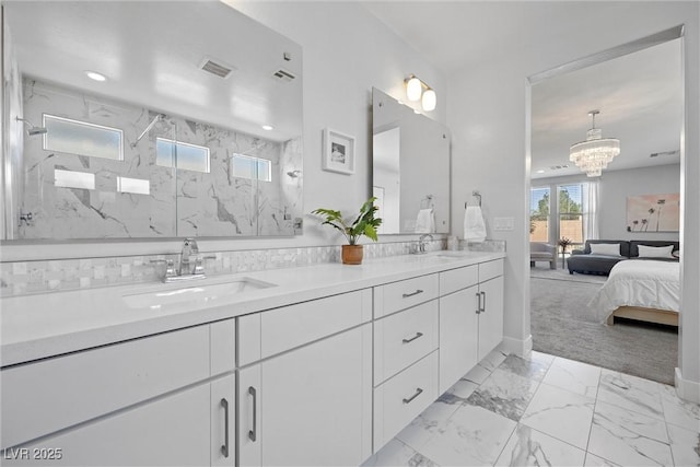 8440 Footpath St, Las Vegas, NV 89166 - full bath with double vanity, connected bathroom, marble look tile flooring, a marble finish shower, and a chandelier