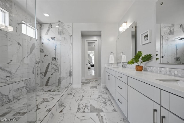 8440 Footpath St, Las Vegas, NV 89166 - bathroom with a marble finish shower, double vanity, marble finish floors, recessed lighting, and baseboards