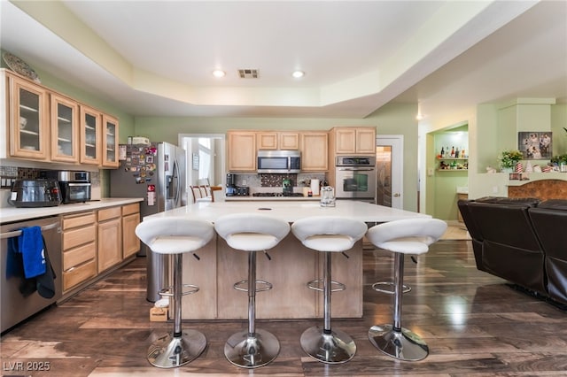 9000 Cotton Rose Way, Las Vegas, NV 89134 - kitchen featuring dark wood-style flooring, visible vents, appliances with stainless steel finishes, and light brown cabinetry