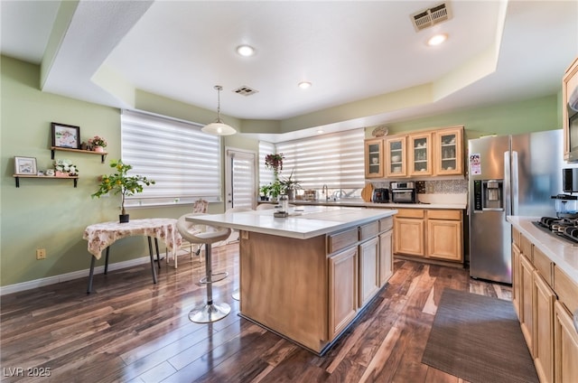 9000 Cotton Rose Way, Las Vegas, NV 89134 - kitchen with visible vents, glass insert cabinets, light countertops, dark wood finished floors, and stainless steel appliances