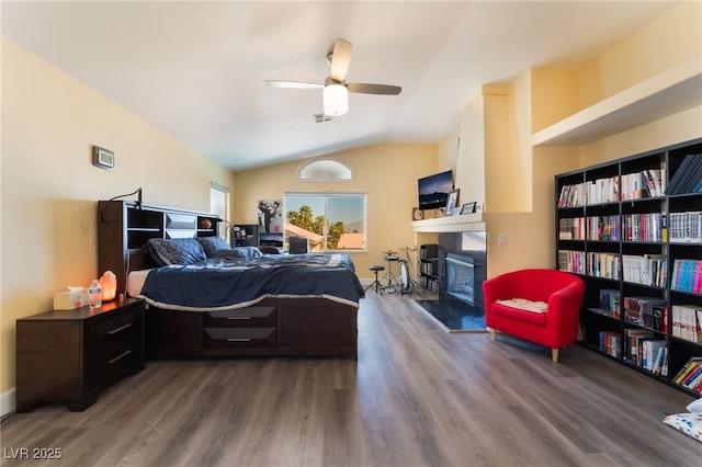 9000 Cotton Rose Way, Las Vegas, NV 89134 - bedroom with ceiling fan, a fireplace with raised hearth, vaulted ceiling, visible vents, and wood finished floors