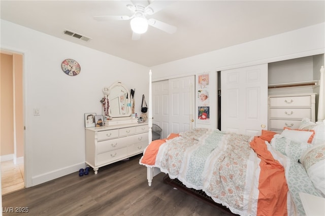 9000 Cotton Rose Way, Las Vegas, NV 89134 - bedroom featuring visible vents, baseboards, ceiling fan, dark wood finished floors, and multiple closets