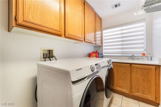 9000 Cotton Rose Way, Las Vegas, NV 89134 - laundry room featuring visible vents, washer and dryer, a sink, cabinet space, and light tile patterned flooring