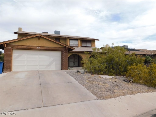 view of front facade featuring a garage, stucco siding, brick siding, and concrete driveway