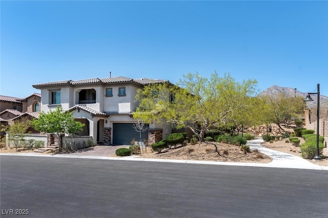 257 Elder View Dr, Las Vegas, NV 89138 - view of front facade with stucco siding, an attached garage, a balcony, a tiled roof, and driveway