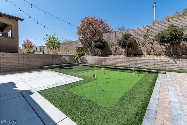 257 Elder View Dr, Las Vegas, NV 89138 - fenced backyard with an area to practice putting and a patio