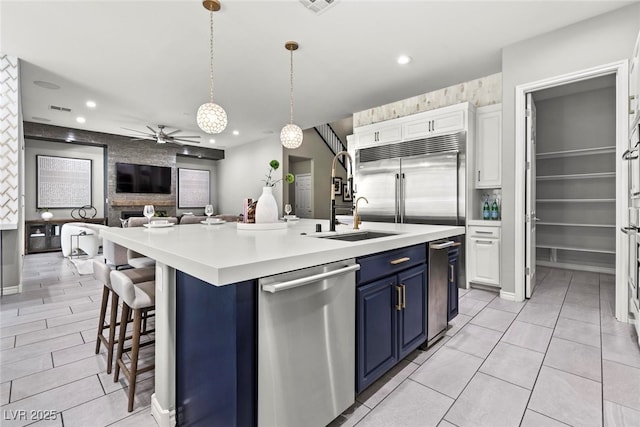 257 Elder View Dr, Las Vegas, NV 89138 - kitchen featuring blue cabinetry, stainless steel appliances, a sink, open floor plan, and ceiling fan