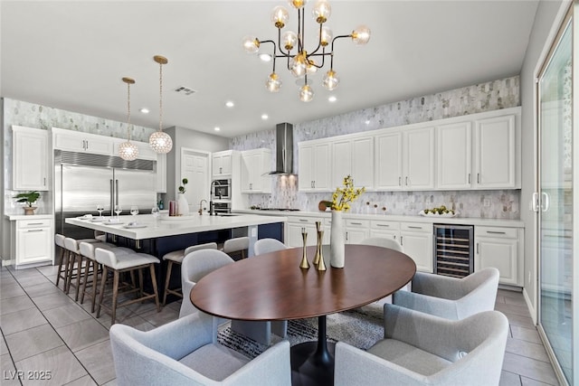 257 Elder View Dr, Las Vegas, NV 89138 - dining area featuring beverage cooler, light tile patterned flooring, a chandelier, recessed lighting, and wallpapered walls