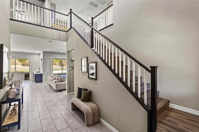 257 Elder View Dr, Las Vegas, NV 89138 - staircase featuring baseboards and a high ceiling