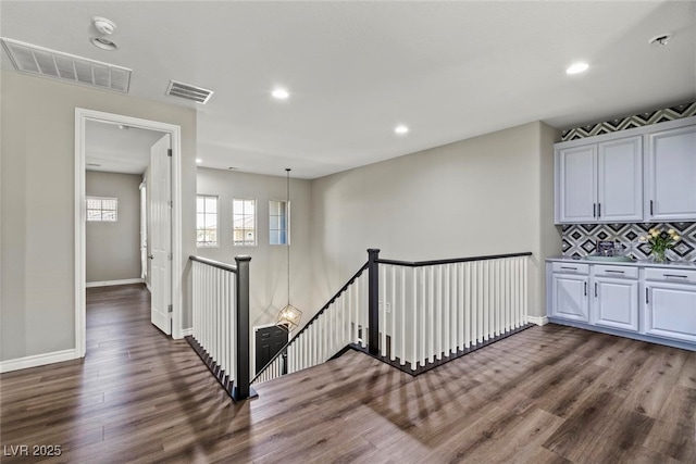257 Elder View Dr, Las Vegas, NV 89138 - hallway with an upstairs landing, dark wood-style flooring, recessed lighting, and baseboards