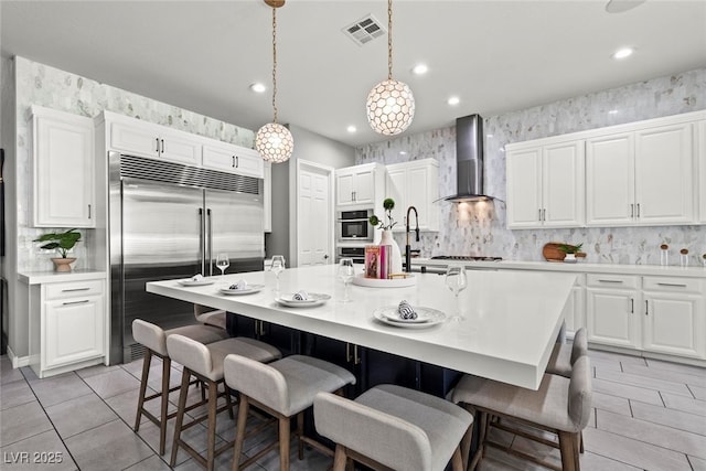 257 Elder View Dr, Las Vegas, NV 89138 - kitchen featuring wall chimney range hood, built in fridge, white cabinets, and recessed lighting