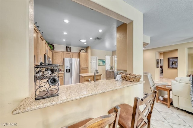 1862 Redwood Valley St, Henderson, NV 89052 - kitchen with light tile patterned flooring, a sink, stainless steel appliances, a peninsula, and visible vents
