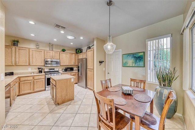 1862 Redwood Valley St, Henderson, NV 89052 - kitchen featuring light brown cabinetry, appliances with stainless steel finishes, light countertops, light tile patterned floors, and visible vents