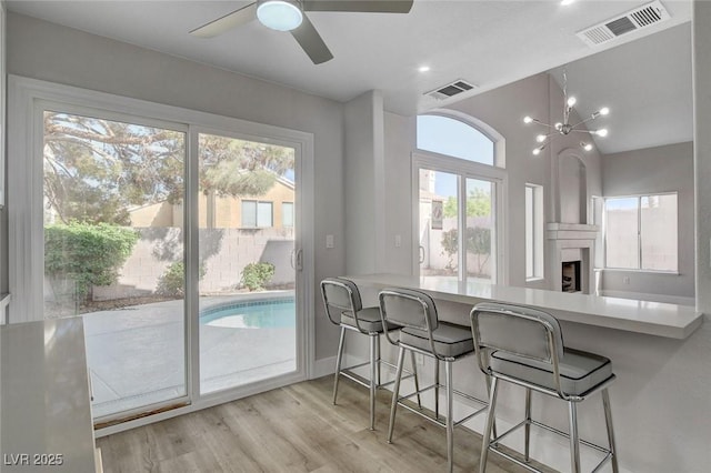2212 Warm Walnut Dr, Las Vegas, NV 89134 - dining space featuring healthy amount of natural light, wood finished floors, ceiling fan, vaulted ceiling, and baseboards