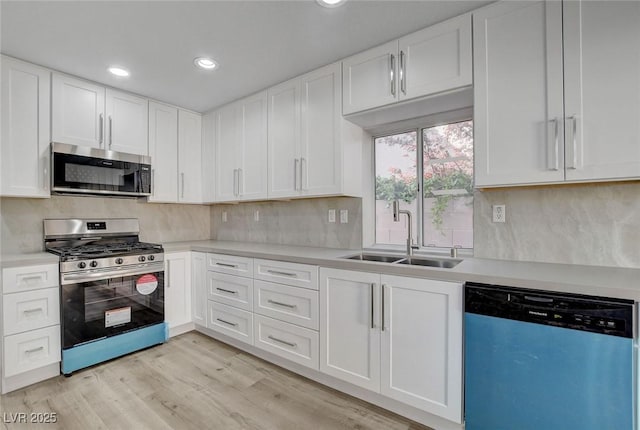 2212 Warm Walnut Dr, Las Vegas, NV 89134 - kitchen featuring stainless steel appliances, a sink, light countertops, backsplash, and white cabinets
