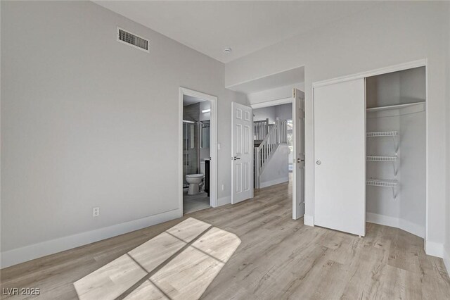 2212 Warm Walnut Dr, Las Vegas, NV 89134 - unfurnished bedroom featuring a closet, baseboards, wood finished floors, and ensuite bathroom