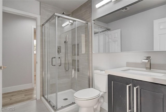 2212 Warm Walnut Dr, Las Vegas, NV 89134 - bathroom featuring a stall shower, toilet, vanity, and wood finished floors