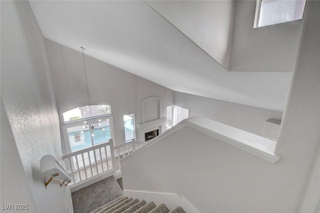 2212 Warm Walnut Dr, Las Vegas, NV 89134 - staircase with a chandelier, healthy amount of natural light, carpet flooring, and high vaulted ceiling