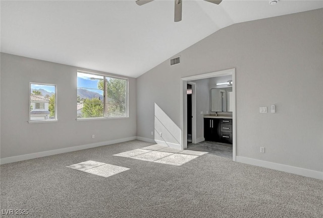 2212 Warm Walnut Dr, Las Vegas, NV 89134 - unfurnished bedroom with lofted ceiling, light carpet, baseboards, connected bathroom, and a ceiling fan