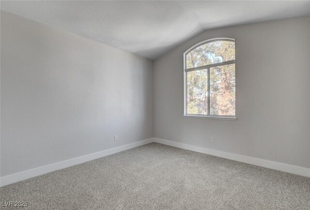 2212 Warm Walnut Dr, Las Vegas, NV 89134 - carpeted empty room featuring lofted ceiling and baseboards