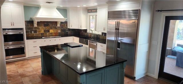 5312 Manuel Dr, Las Vegas, NV 89149 - kitchen with visible vents, decorative backsplash, dark countertops, custom range hood, and appliances with stainless steel finishes