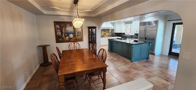 5312 Manuel Dr, Las Vegas, NV 89149 - dining space with plenty of natural light, baseboards, a raised ceiling, and arched walkways
