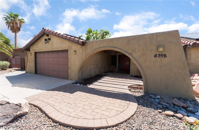 5312 Manuel Dr, Las Vegas, NV 89149 - view of front of property with a garage, concrete driveway, and a tiled roof