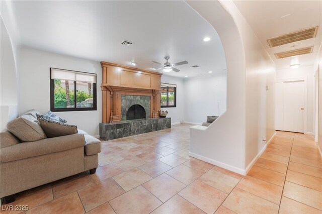 5312 Manuel Dr, Las Vegas, NV 89149 - living room featuring a ceiling fan, a premium fireplace, light tile patterned floors, baseboards, and recessed lighting
