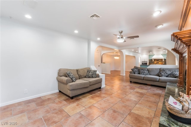 5312 Manuel Dr, Las Vegas, NV 89149 - living area with arched walkways, ceiling fan, recessed lighting, and baseboards