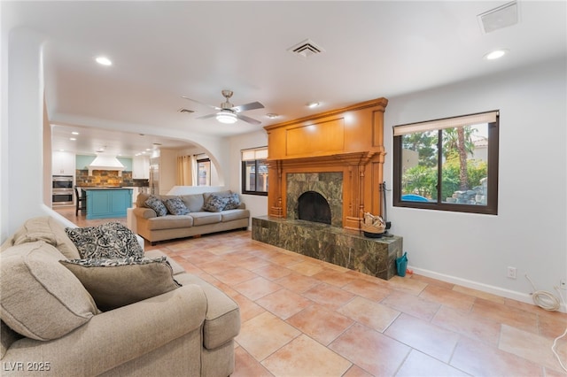 5312 Manuel Dr, Las Vegas, NV 89149 - living area with a fireplace, plenty of natural light, arched walkways, baseboards, and recessed lighting