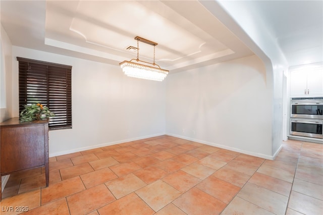 5312 Manuel Dr, Las Vegas, NV 89149 - empty room with a raised ceiling, baseboards, and light tile patterned floors