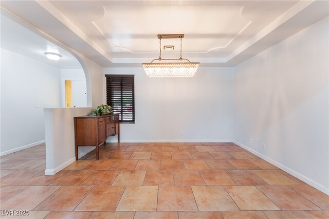 5312 Manuel Dr, Las Vegas, NV 89149 - unfurnished room featuring a raised ceiling, arched walkways, and baseboards