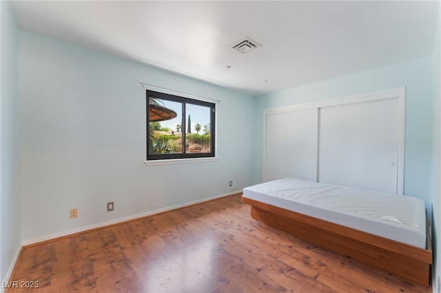 5312 Manuel Dr, Las Vegas, NV 89149 - bedroom featuring baseboards, wood finished floors, and a closet