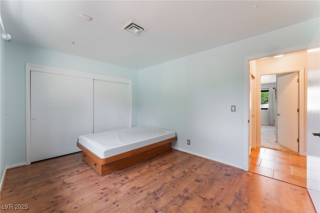 5312 Manuel Dr, Las Vegas, NV 89149 - bedroom featuring wood finished floors and a closet