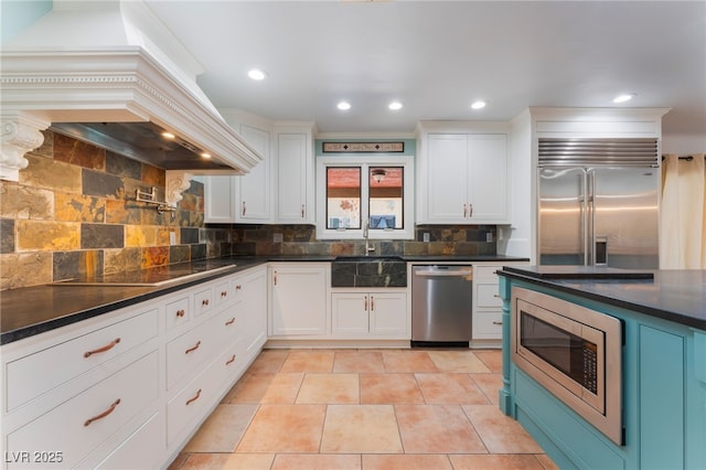 5312 Manuel Dr, Las Vegas, NV 89149 - kitchen featuring built in appliances, dark countertops, a sink, custom range hood, and decorative backsplash