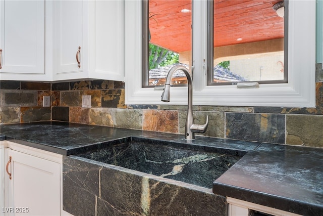 5312 Manuel Dr, Las Vegas, NV 89149 - detailed view of white cabinets, decorative backsplash, and a sink