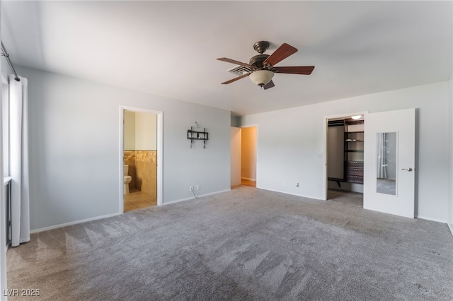5312 Manuel Dr, Las Vegas, NV 89149 - unfurnished bedroom featuring carpet floors, baseboards, ensuite bath, a spacious closet, and a ceiling fan