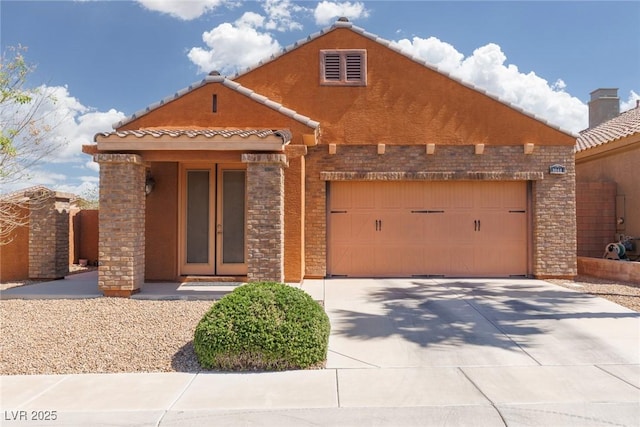 view of front of home featuring an attached garage, concrete driveway, and stucco siding