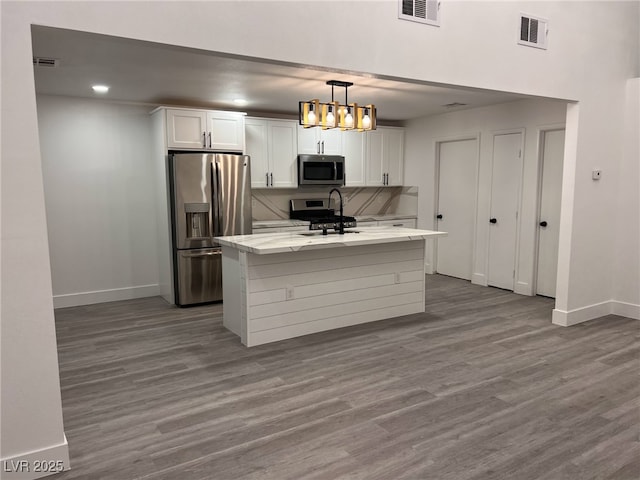 3686 Lincoln Rd, Las Vegas, NV 89115 - kitchen with visible vents, baseboards, white cabinetry, and stainless steel appliances