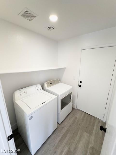 3686 Lincoln Rd, Las Vegas, NV 89115 - laundry room featuring washing machine and dryer, laundry area, visible vents, and light wood-style flooring