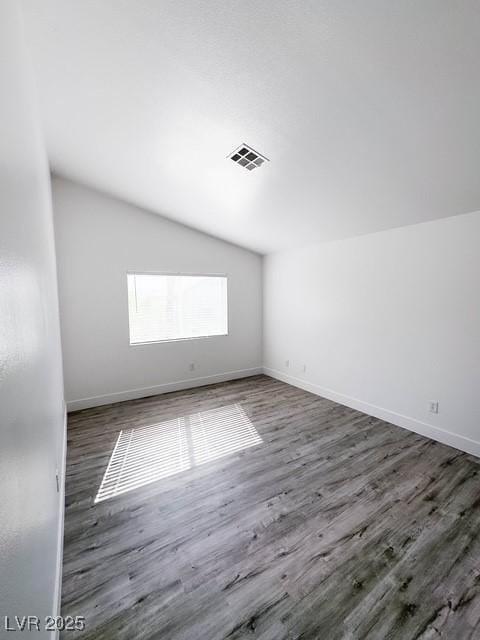 3686 Lincoln Rd, Las Vegas, NV 89115 - spare room featuring lofted ceiling, visible vents, and wood finished floors