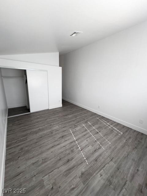 3686 Lincoln Rd, Las Vegas, NV 89115 - unfurnished bedroom featuring dark wood finished floors, baseboards, visible vents, and a closet