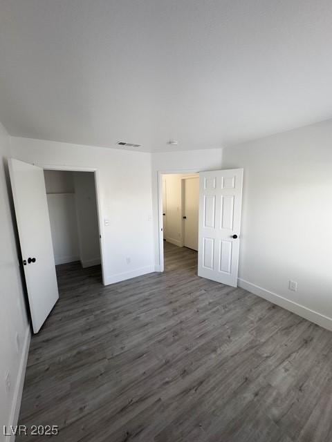3686 Lincoln Rd, Las Vegas, NV 89115 - unfurnished bedroom featuring baseboards, dark wood-type flooring, and visible vents